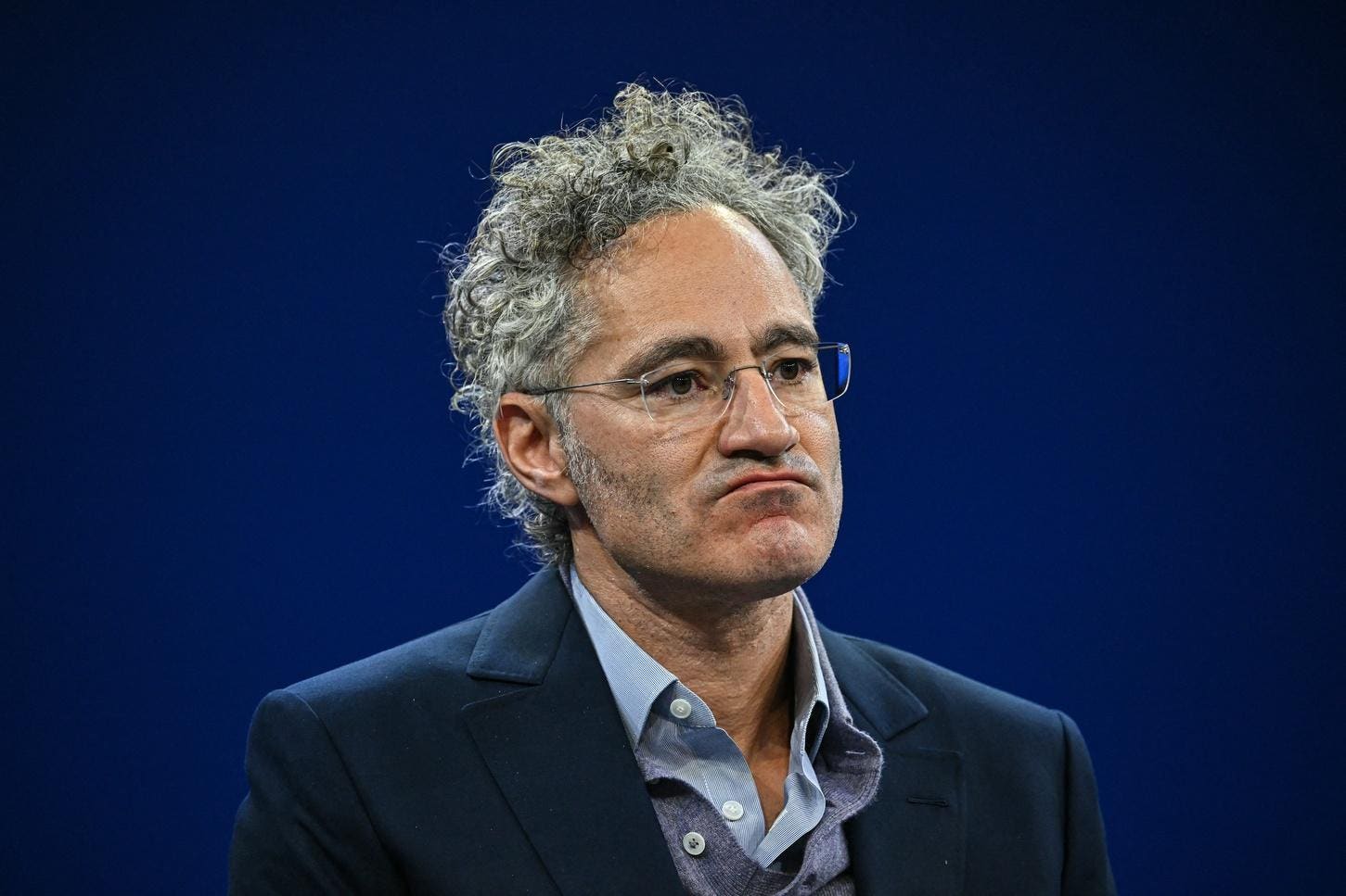 Alex Karp calls US reliance on AI labs for military tech "effing insane", pans AI fees for businesses, and touts Palantir's Nvidia Nemotron deal for US agencies